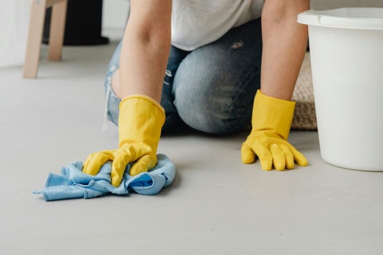 woman cleaning floor, thinking about belonging in God's family rather than feeling like a guest